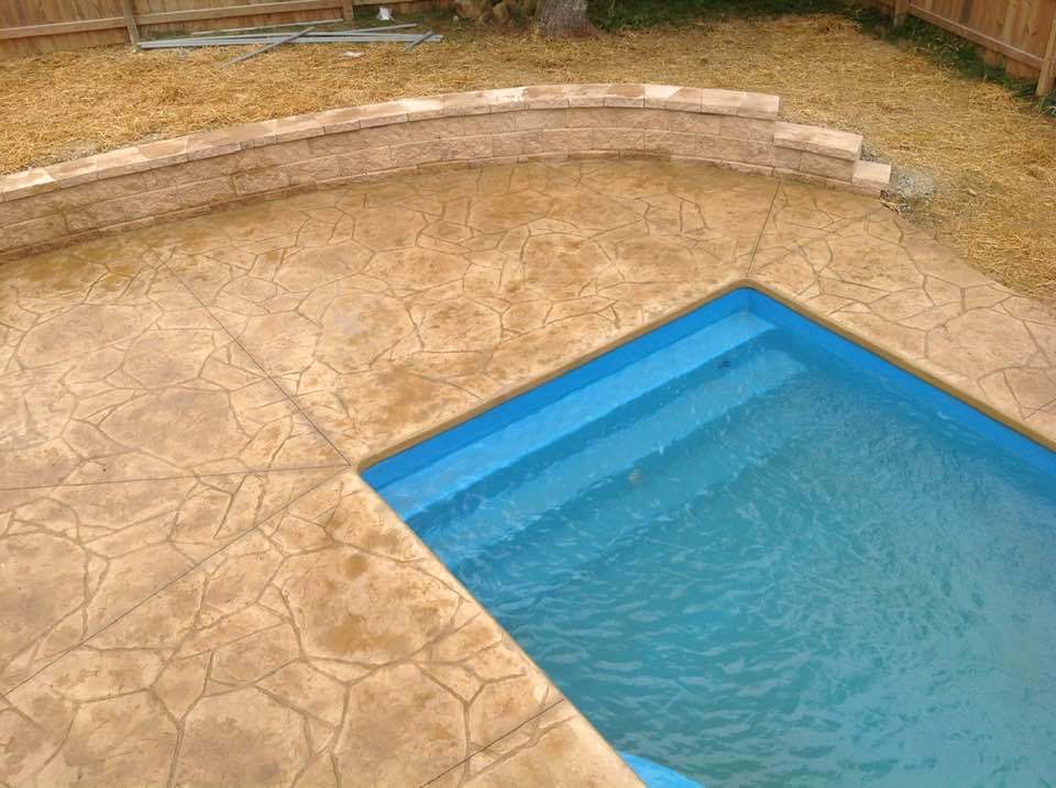 Experience tranquility with this beautifully designed fiberglass inground pool set in a serene backyard.