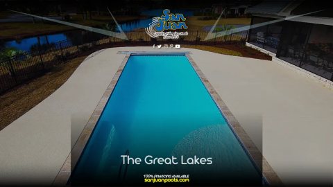 Finished fiberglass inground pool with turquoise water in a backyard