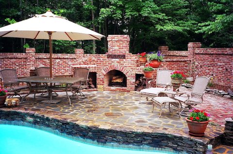 Partial fiberglass inground pool with turquoise water in a backyard setting.